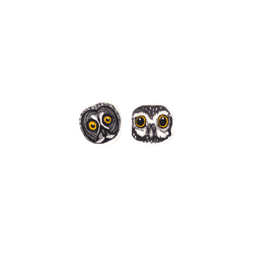 &Ouml;&ouml;kullid K&otilde;rvar&otilde;ngad: two small owl face earrings with yellow eyes and black & white details, shown side by side on a white background&mdash;a delightful piece of Estonian design for the modern concept shop. Gate21.ee